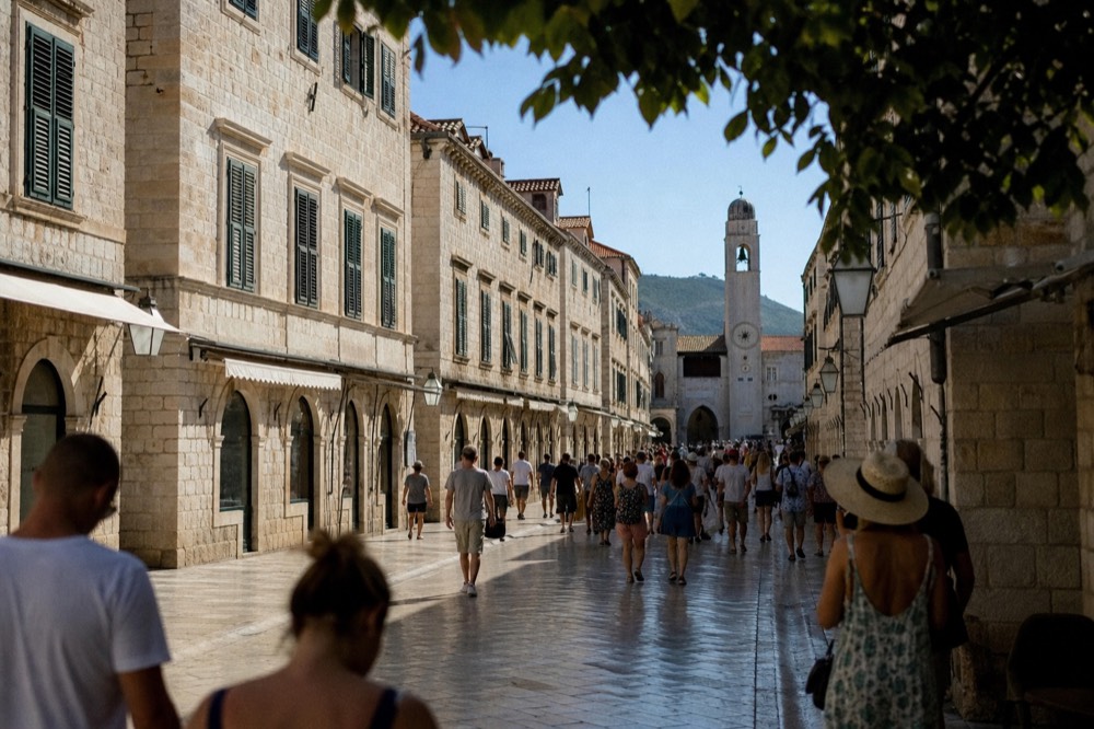 Crowds of visitors walking along the Stradun in Dubrovnik Old Town on a bright summer morning