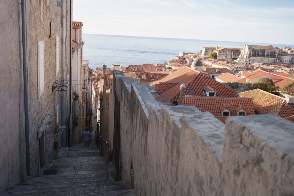 Terracotta rooftops of Dubrovnik Old Town with the Adriatic Sea beyond