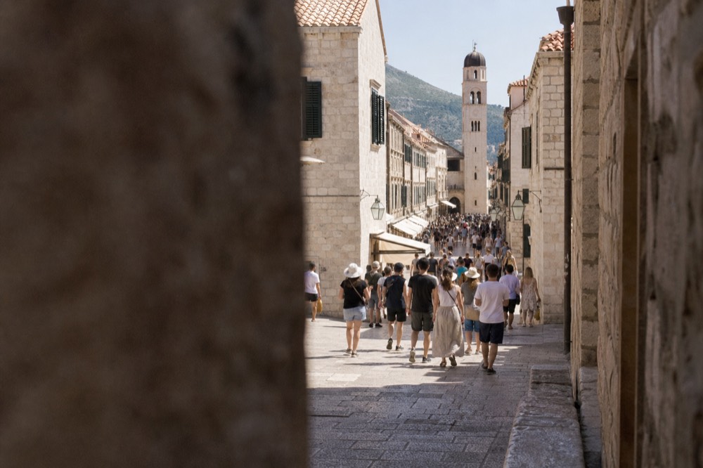 Crowds of visitors walking the Stradun in Dubrovnik at midday