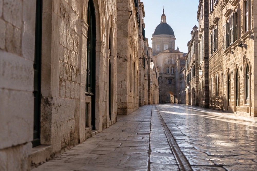 An empty limestone street in Dubrovnik Old Town in early morning light