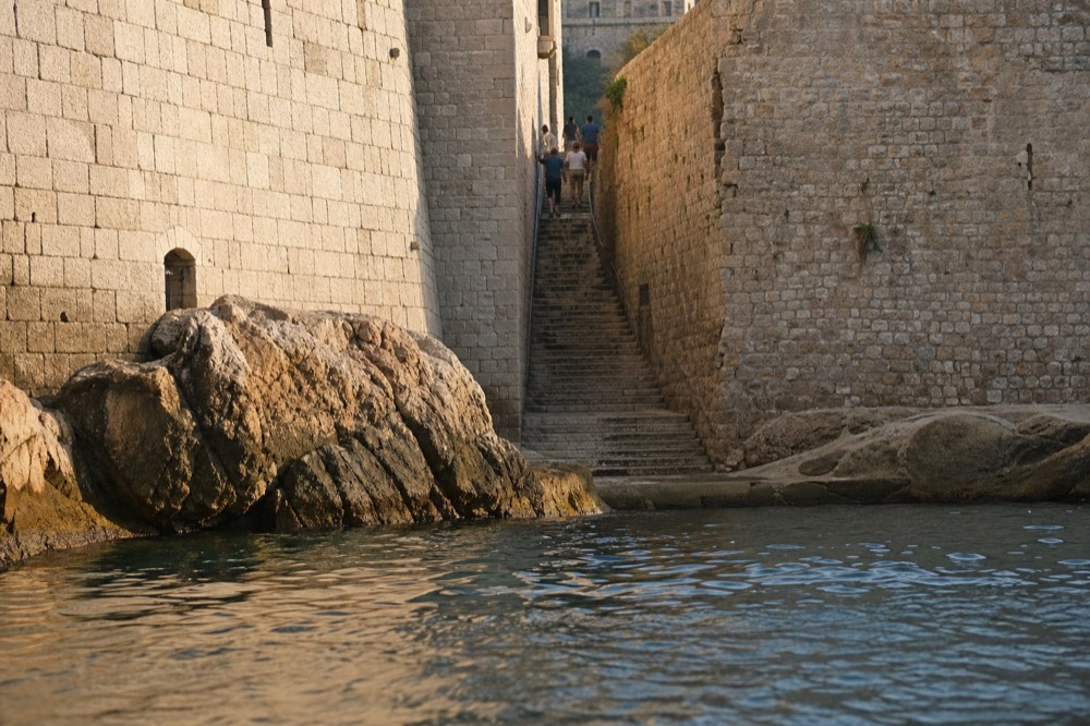 A steep stone staircase between high walls in Dubrovnik Old Town