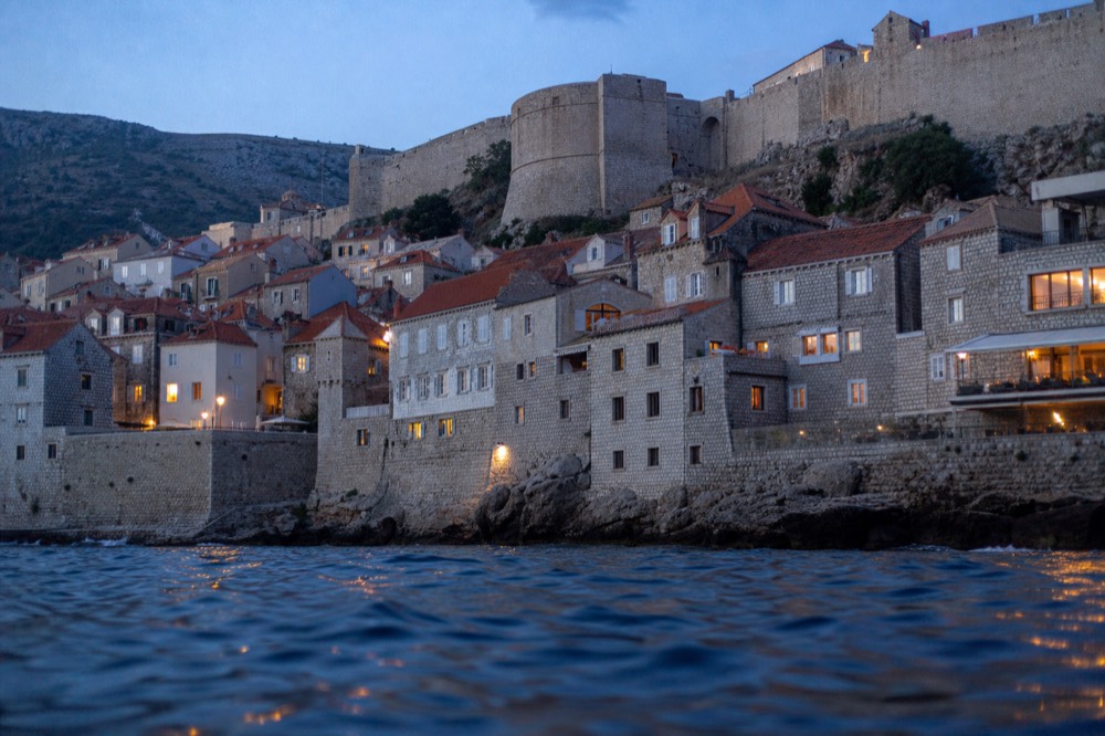 Stone fortification walls and towers above the old town rooftops