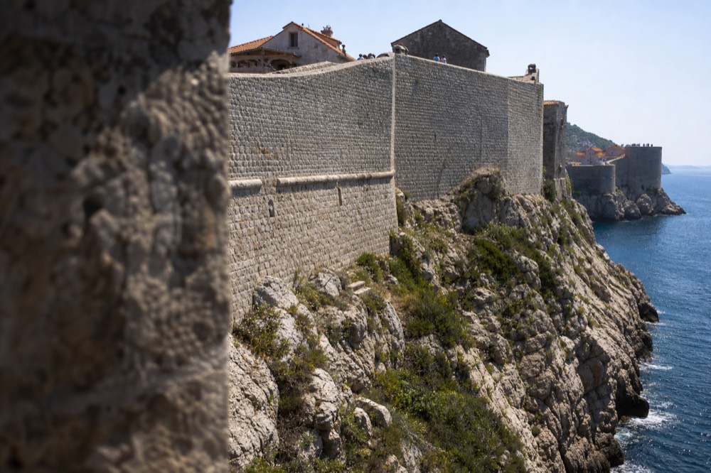 Fortress walls standing on a rocky outcrop above the sea