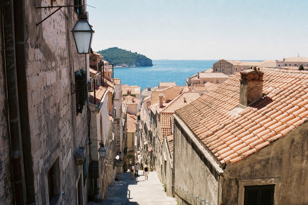 Steep stone staircase between tall houses in Dubrovnik Old Town