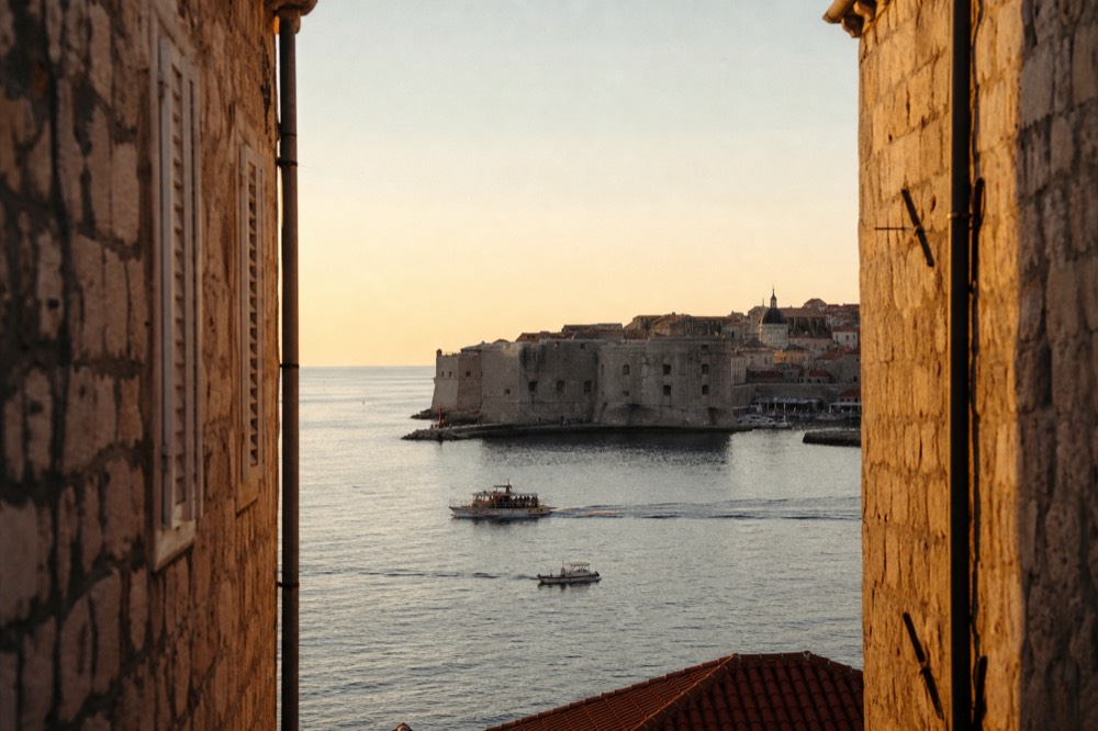 Evening lights reflecting on the stone walls and rooftops of Dubrovnik Old Town
