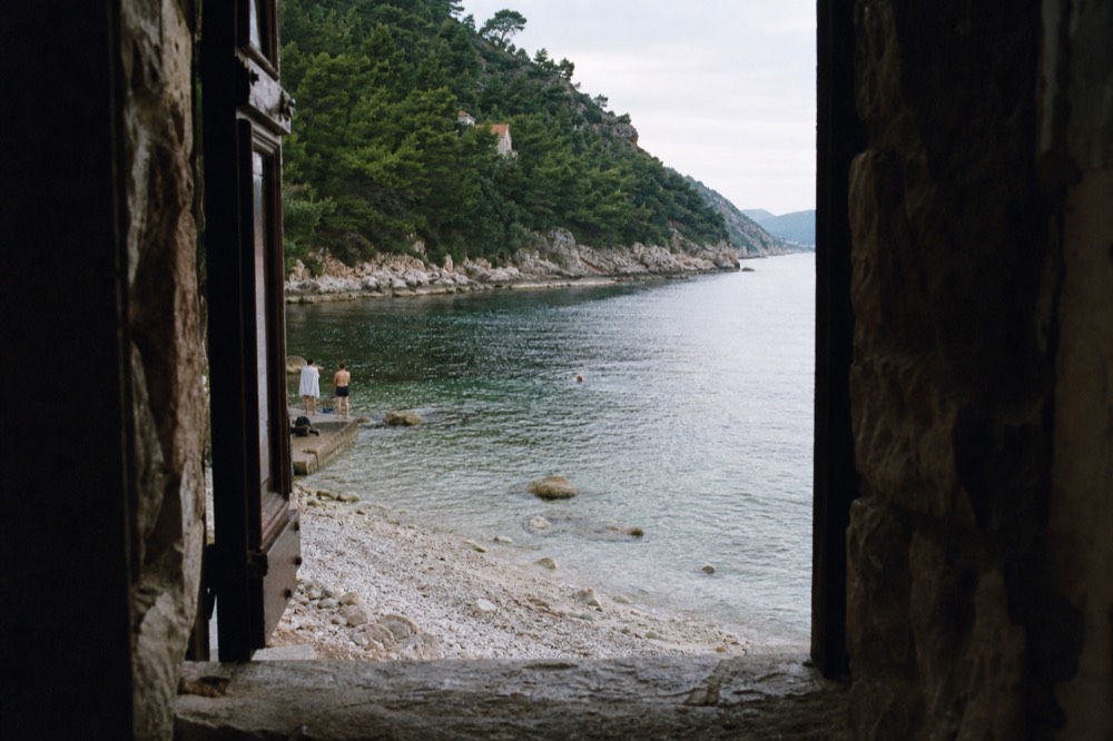 Clear shallow water over pale stones at a small cove near Dubrovnik