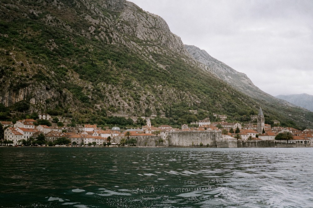 Walled old town of Kotor with mountain slopes rising directly behind the rooftops