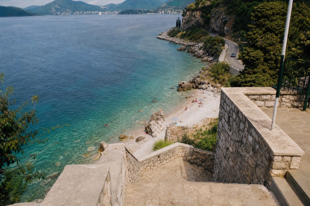 Coastal road curving along the shoreline south of Dubrovnik toward the Montenegro border