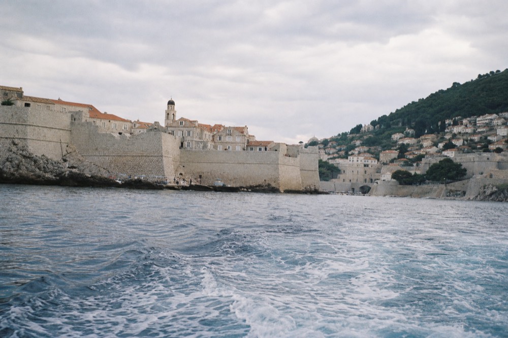 Passenger boat departing Dubrovnik Old City Harbour toward Lokrum island