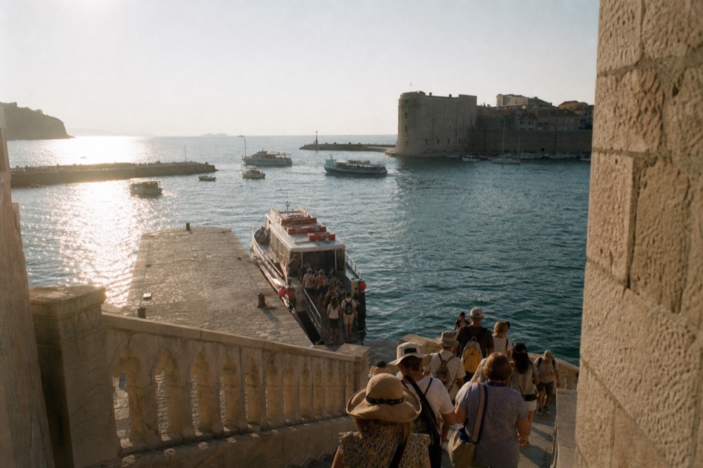 Passengers boarding a small ferry boat at Dubrovnik old city harbour