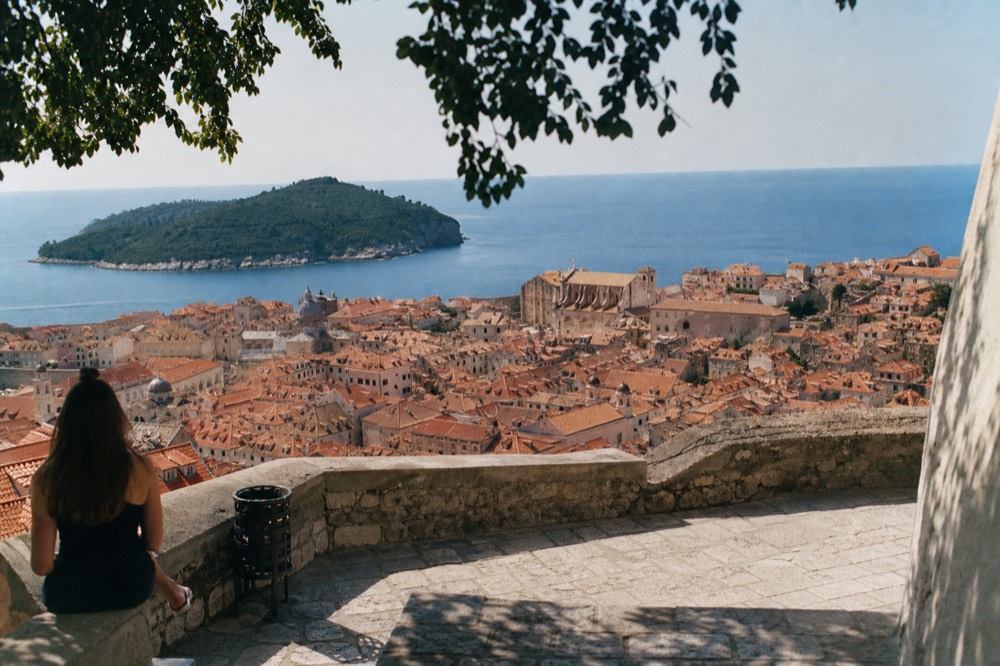 Terracotta rooftops of Dubrovnik Old Town seen from above with the sea beyond