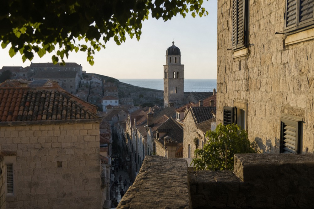 Old stone buildings and a bell tower above narrow lanes in Dubrovnik
