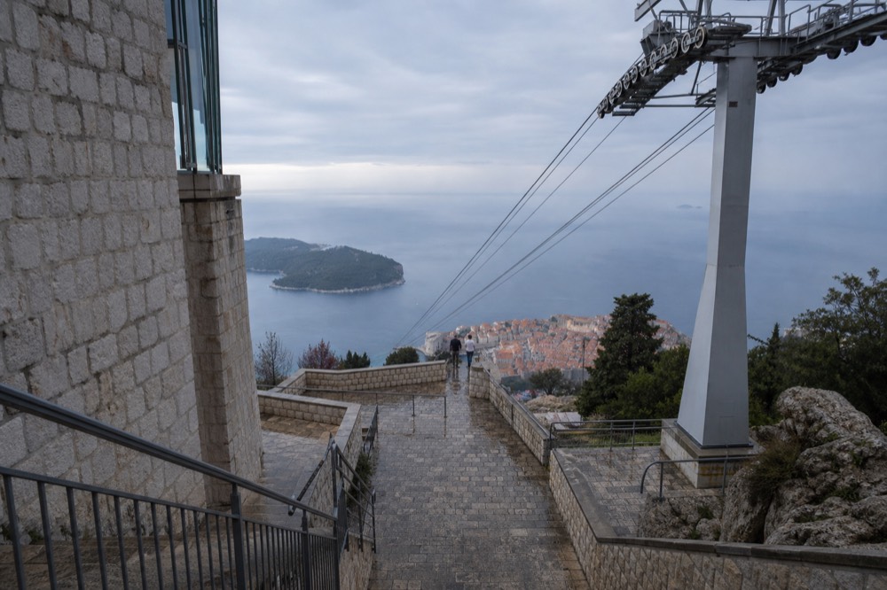 The terrac rooftops of Dubrovnik Old Town and the island of Lokrum seen from the upper cable car station on Mount Srd