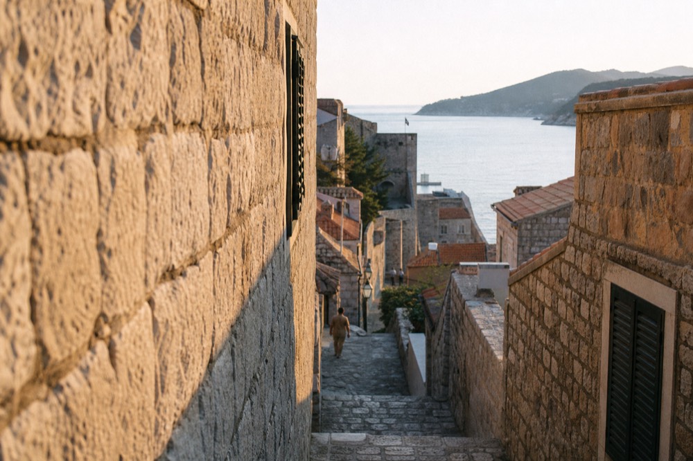 Narrow stone side street in the old town with worn steps and shuttered windows