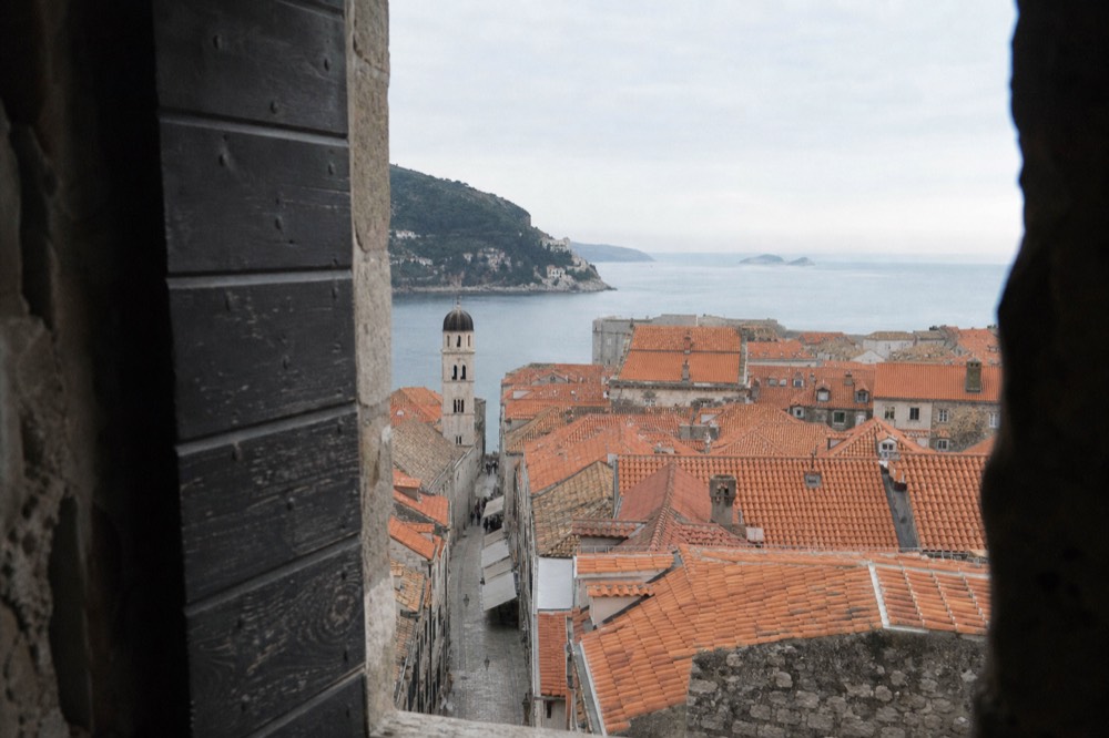An early morning view over Dubrovnik rooftops with empty streets below