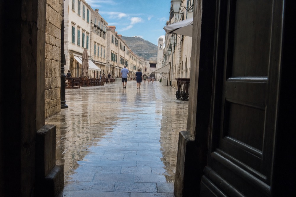 Polished limestone paving stones shining after rain in an old town street