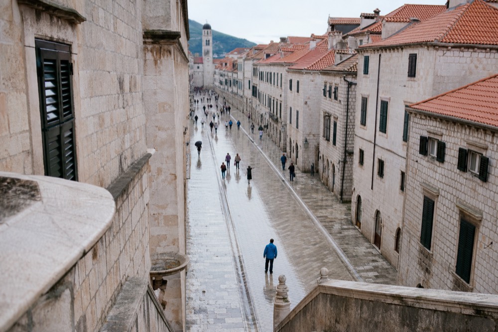 Smooth limestone-paved main street in Dubrovnik lined with stone buildings