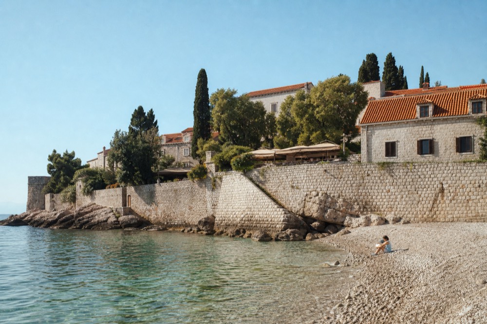 Calm sheltered bay in warm autumn light with gentle waves on clear water