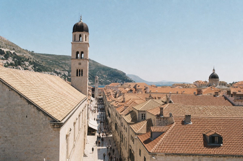 Pedestrians walking the stone main street of Dubrovnik Old Town