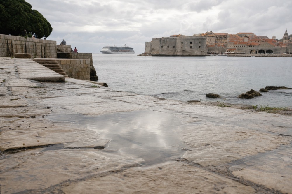 Cruise ship anchored off the walled city of Dubrovnik in morning light