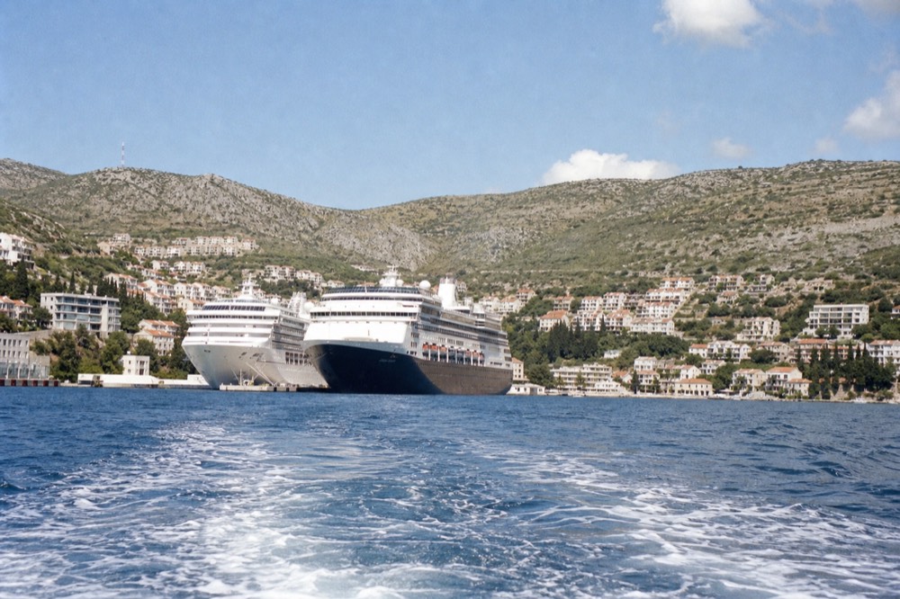 Cruise ships moored at the Gruž port with the Adriatic and hills behind