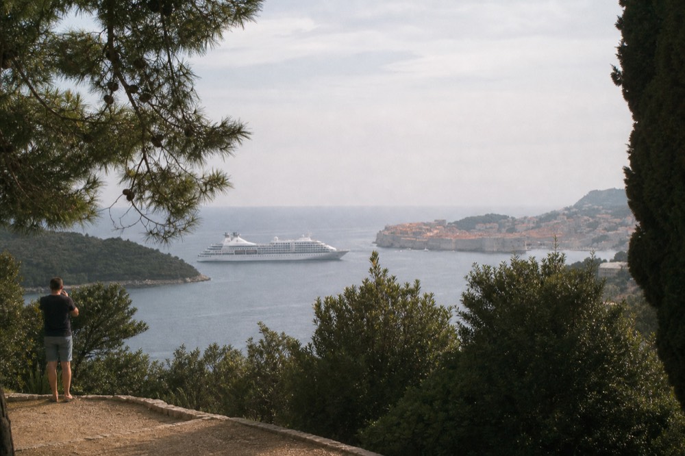 cruise ship anchored off Dubrovnik old town seen across the water