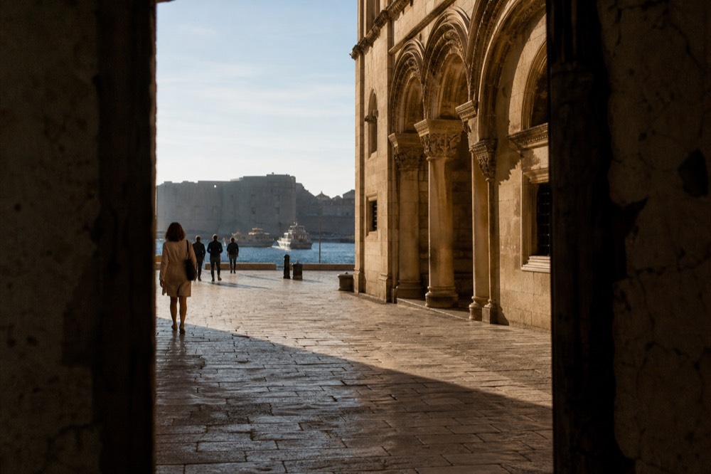 ornate stone palace facade on a wide limestone street in Dubrovnik
