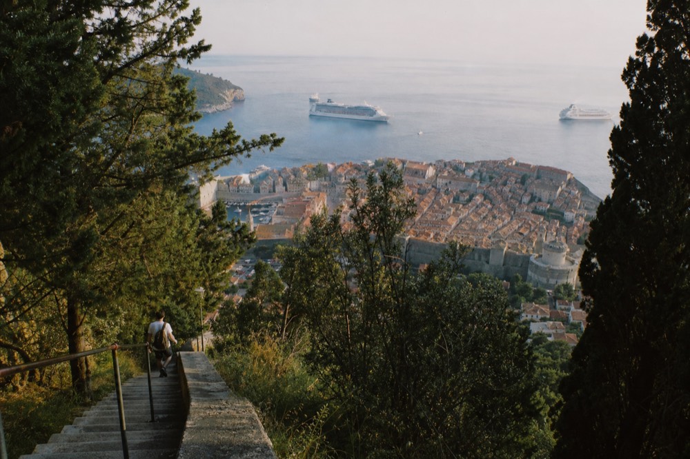 Cruise ships anchored outside the Old Town harbour of Dubrovnik in calm evening light