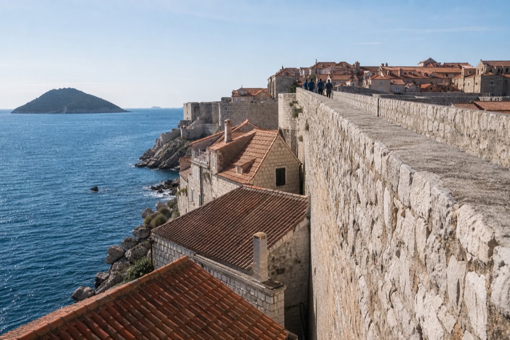 The stone walls and terracotta roofs of Dubrovnik under a pale winter sky