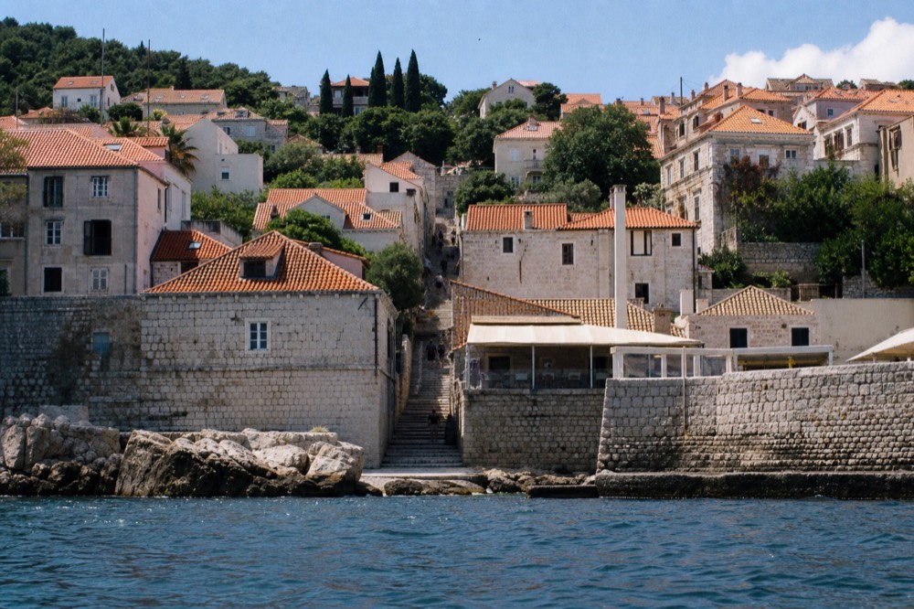 Steep stone staircase street climbing between old houses in Dubrovnik
