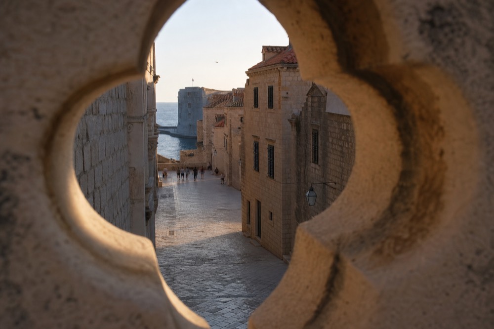 Wide limestone street lined with stone buildings in Dubrovnik Old Town