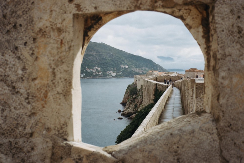 Walking the city walls in morning light with the Adriatic beyond