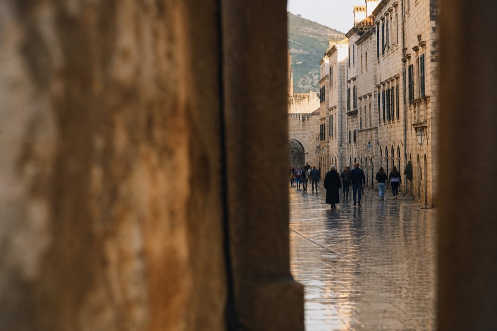 Rain-slicked Stradun street in Dubrovnik Old Town with wet stone paving glistening
