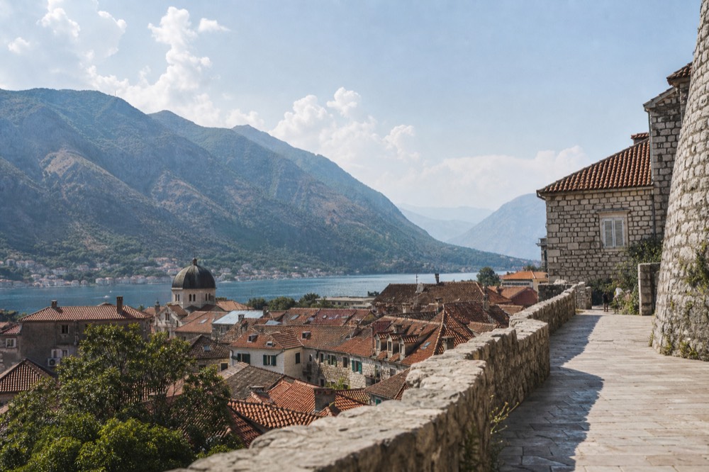 Kotor old town rooftops in Montenegro beneath misty mountains