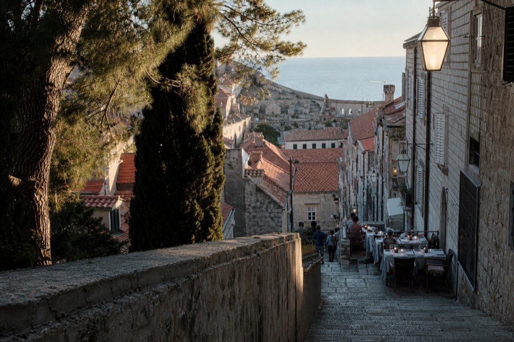 Evening tables set along a narrow stone street in Dubrovnik Old Town