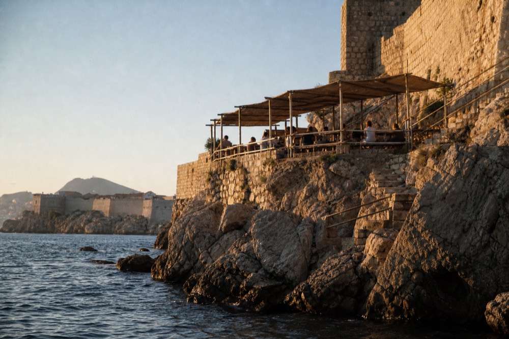 A terrace perched on the cliffs outside the city walls above the open sea